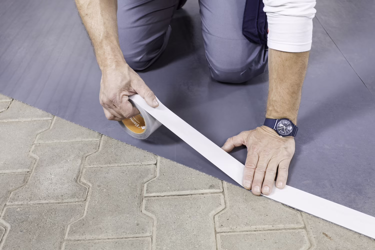 Apply the Sigan Elements Plus tape along the edges of the UZIN RR 185 reinforcement underlay. This provides increased adhesive strength in the edge areas.