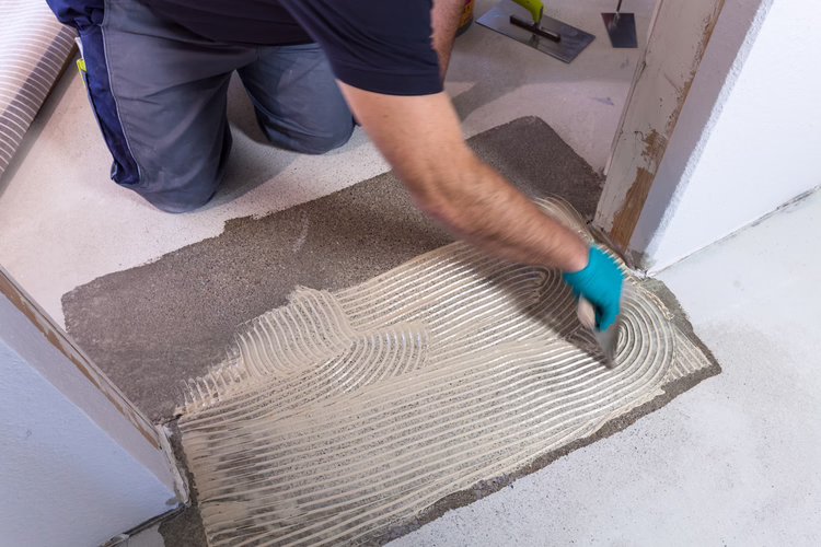 Mix 2-component P-U-R wood flooring adhesive UZIN MK 92 S with a drill and stirrer attachment. Ensure its well mixed and spread immediately onto the substrate with B11 sized notch trowel.